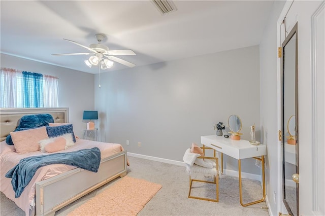 bedroom with ceiling fan and light colored carpet