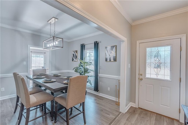 dining room featuring hardwood / wood-style flooring and ornamental molding