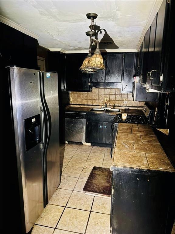 kitchen featuring sink, crown molding, light tile patterned floors, stainless steel appliances, and backsplash