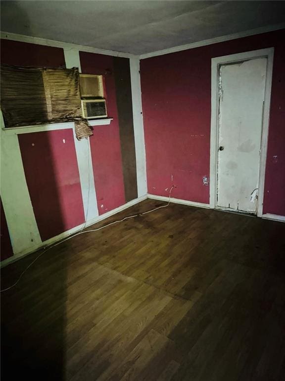 spare room featuring cooling unit and wood-type flooring