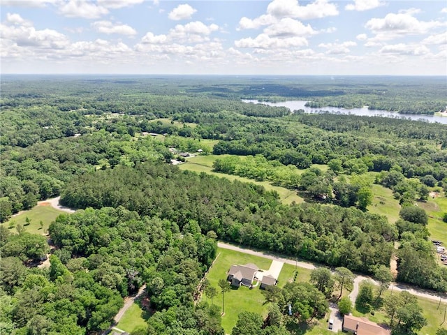 aerial view of a heavily wooded area and a nearby body of water
