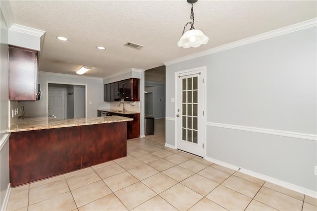 kitchen featuring crown molding, a sink, a peninsula, and light tile patterned floors