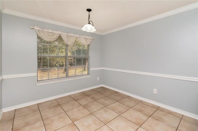 unfurnished dining area with light tile patterned floors, baseboards, and ornamental molding