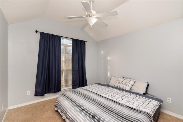 bedroom with light carpet, vaulted ceiling, a ceiling fan, and baseboards