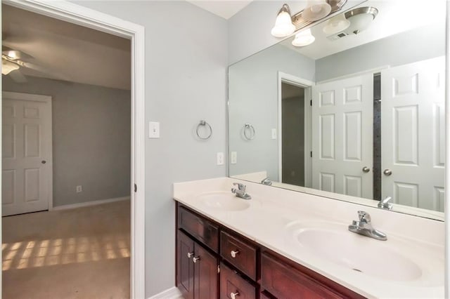 full bath with a ceiling fan, visible vents, a sink, and double vanity