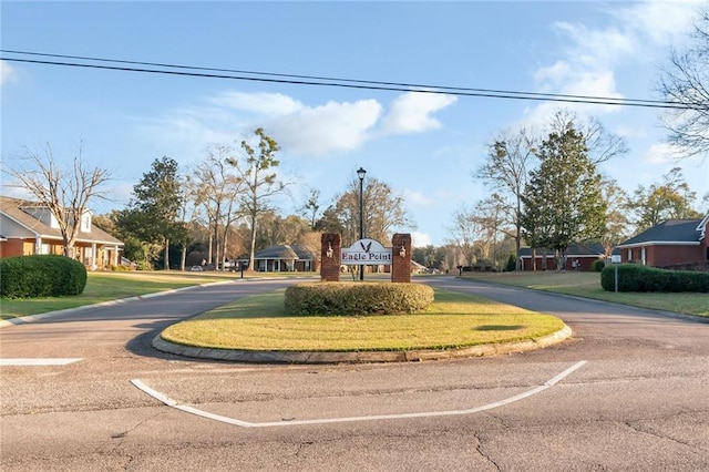 view of road featuring street lights and curbs