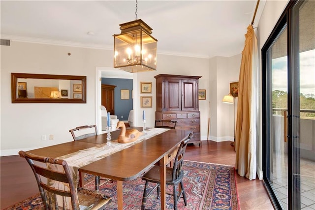 dining area featuring visible vents, baseboards, dark wood-style floors, and ornamental molding