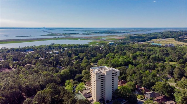 bird's eye view featuring a wooded view and a water view