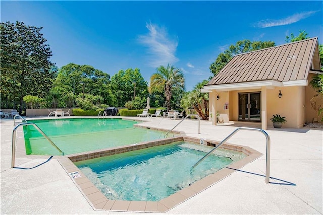 community pool with french doors, a patio, and a community hot tub