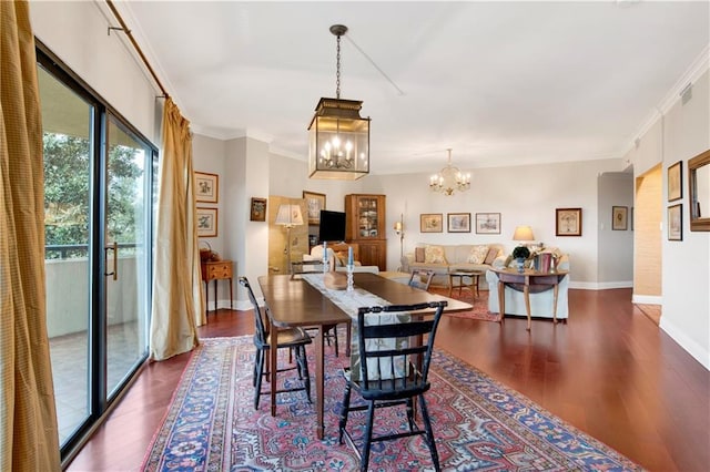 dining space with a chandelier, crown molding, and dark wood-style flooring