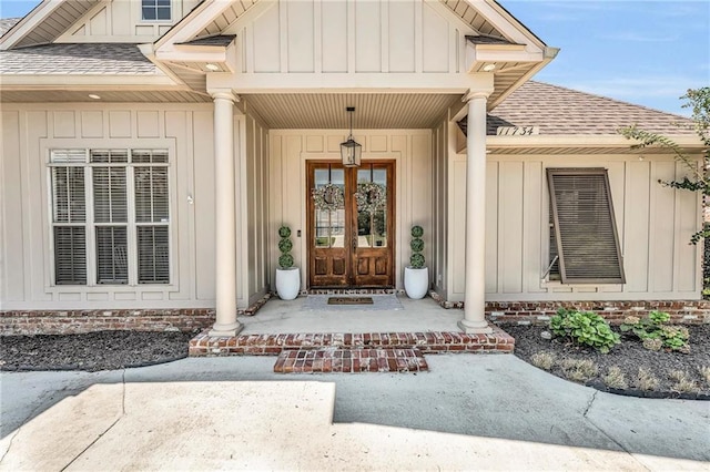 property entrance featuring board and batten siding, a shingled roof, and a porch