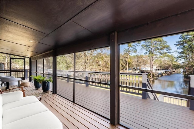 wooden terrace featuring a water view