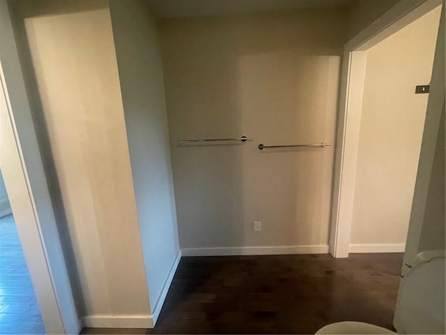 bathroom featuring wood-type flooring and toilet