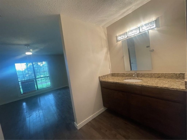 bathroom featuring a textured ceiling, vanity, and hardwood / wood-style flooring