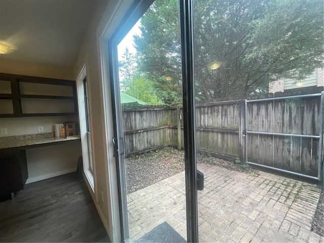 doorway with dark wood-type flooring