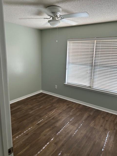 6611 Morgan Jackson Ct, Mobile, AL 36582 - spare room with a ceiling fan, dark wood-style flooring, a textured ceiling, and baseboards