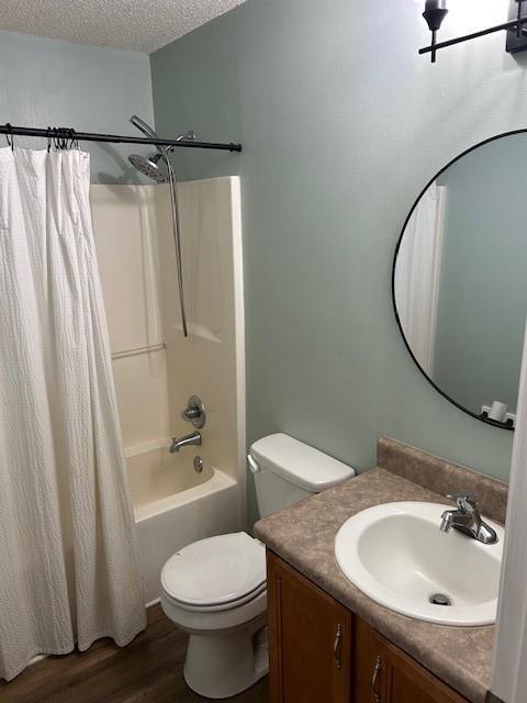 6611 Morgan Jackson Ct, Mobile, AL 36582 - bathroom with vanity, toilet, a textured ceiling, shower / tub combo, and wood finished floors