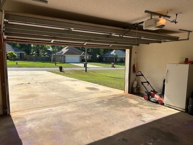6611 Morgan Jackson Ct, Mobile, AL 36582 - garage with freestanding refrigerator and a garage door opener