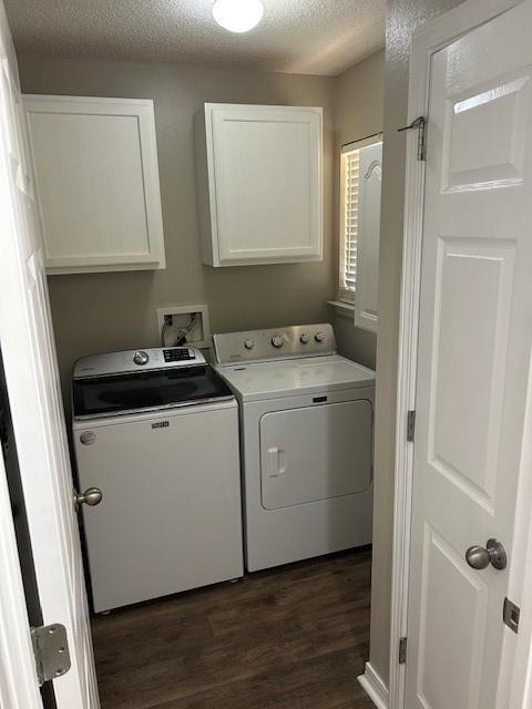 6611 Morgan Jackson Ct, Mobile, AL 36582 - laundry area featuring washing machine and dryer, cabinet space, dark wood-type flooring, and a textured ceiling