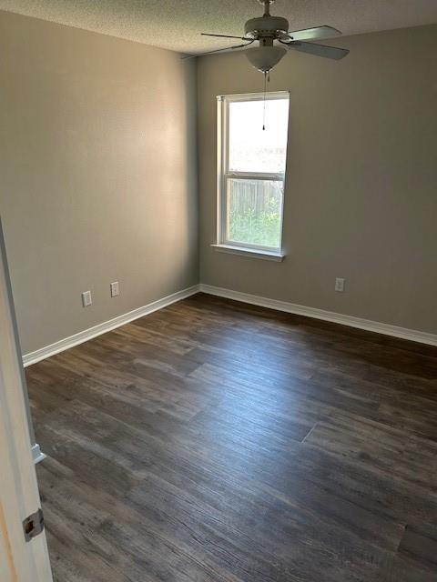 6611 Morgan Jackson Ct, Mobile, AL 36582 - unfurnished room featuring a ceiling fan, dark wood-style flooring, a textured ceiling, and baseboards