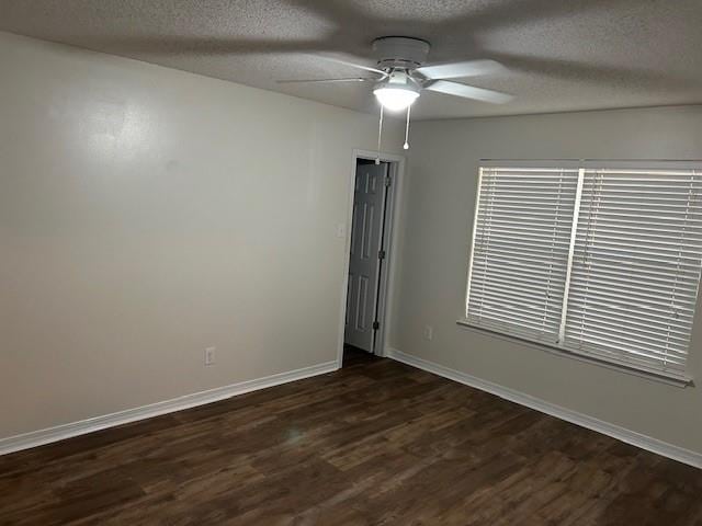 6611 Morgan Jackson Ct, Mobile, AL 36582 - empty room with dark wood-style floors, a ceiling fan, a textured ceiling, and baseboards
