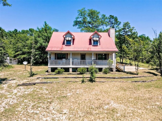 17180 Jim Platt Rd, Citronelle, AL 36522 - cape cod-style house featuring covered porch, a chimney, a front yard, and metal roof