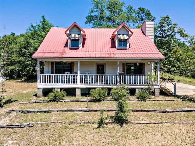 17180 Jim Platt Rd, Citronelle, AL 36522 - view of front facade featuring covered porch, a front yard, metal roof, and a chimney