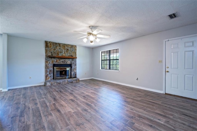 17180 Jim Platt Rd, Citronelle, AL 36522 - unfurnished living room with a ceiling fan, a textured ceiling, dark wood finished floors, baseboards, and a fireplace