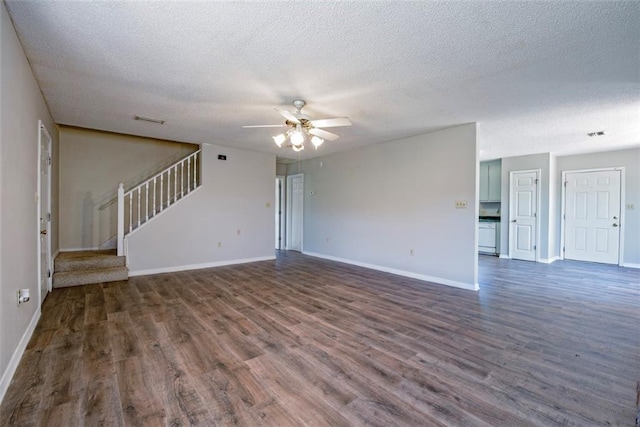 17180 Jim Platt Rd, Citronelle, AL 36522 - unfurnished living room featuring ceiling fan, wood finished floors, a textured ceiling, stairs, and baseboards