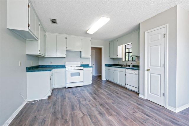 17180 Jim Platt Rd, Citronelle, AL 36522 - kitchen with white appliances, dark wood-style flooring, baseboards, a textured ceiling, and a sink