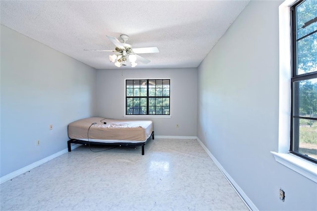 17180 Jim Platt Rd, Citronelle, AL 36522 - bedroom with a textured ceiling, multiple windows, baseboards, and ceiling fan