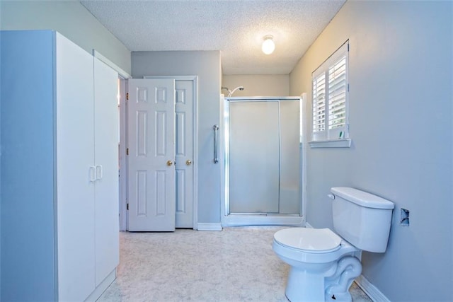 17180 Jim Platt Rd, Citronelle, AL 36522 - full bath with toilet, a shower with door, a textured ceiling, and baseboards