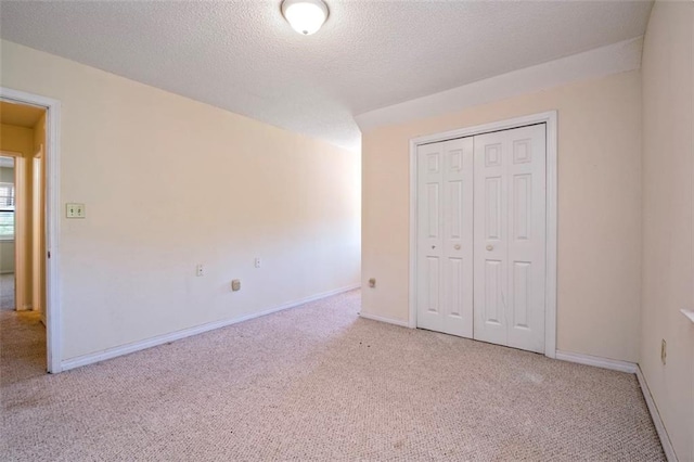17180 Jim Platt Rd, Citronelle, AL 36522 - unfurnished bedroom with light colored carpet, a closet, baseboards, and a textured ceiling