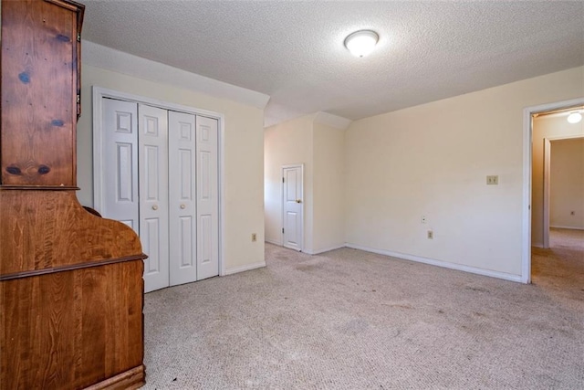 17180 Jim Platt Rd, Citronelle, AL 36522 - unfurnished bedroom with light carpet, a closet, a textured ceiling, and baseboards