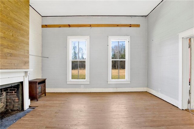 52780 State Highway 59, Stockton, AL 36579 - unfurnished living room with baseboards, a fireplace with flush hearth, and hardwood / wood-style flooring