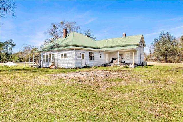 52780 State Highway 59, Stockton, AL 36579 - back of house with central air condition unit, a chimney, and a yard