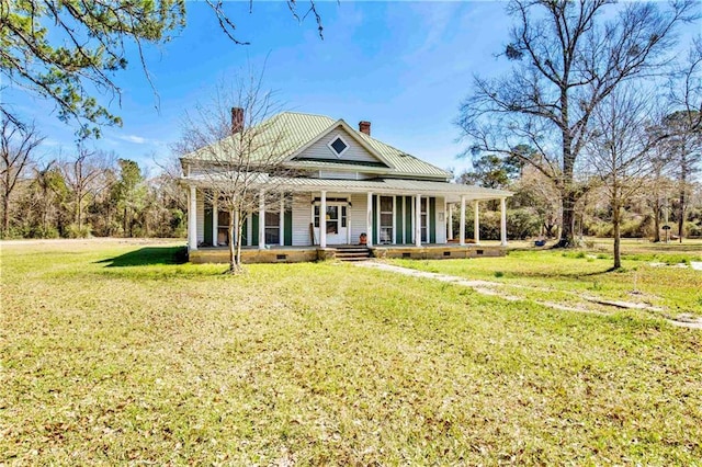 52780 State Highway 59, Stockton, AL 36579 - view of front of house with a porch, a chimney, metal roof, and a front lawn