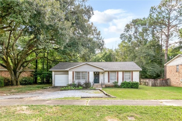 view of front of house with a front yard and a garage