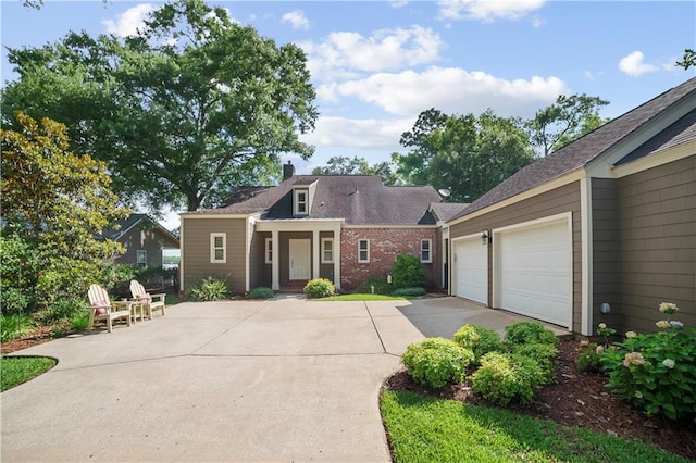3009 Riverside Dr, Mobile, AL 36605 - view of front of home with driveway, an attached garage, a chimney, and brick siding
