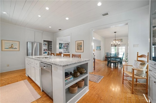 3009 Riverside Dr, Mobile, AL 36605 - kitchen featuring appliances with stainless steel finishes, open shelves, recessed lighting, white cabinetry, and light wood-style floors