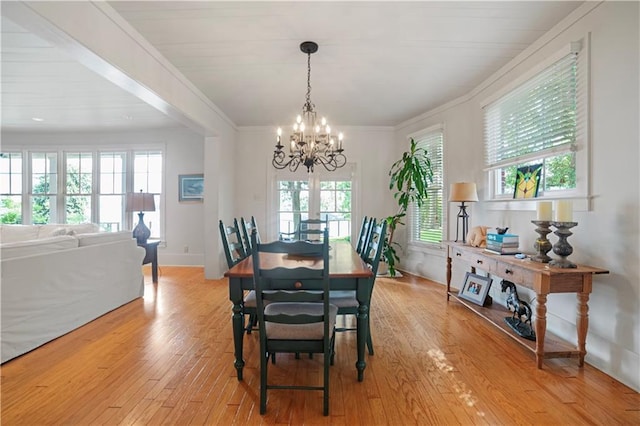 3009 Riverside Dr, Mobile, AL 36605 - dining space with a chandelier, light wood-style flooring, and crown molding