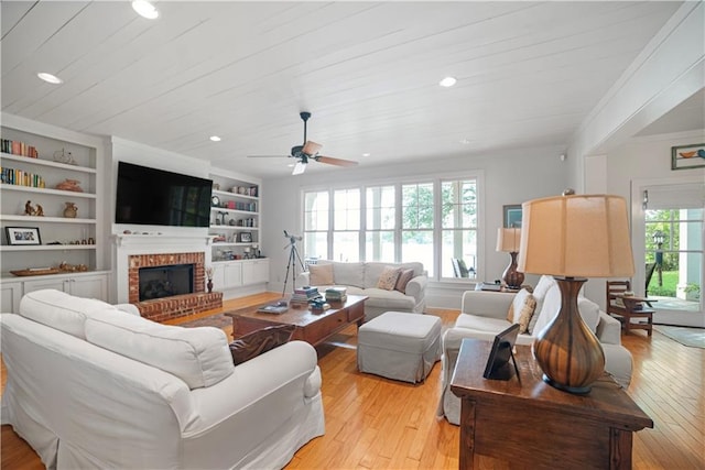 3009 Riverside Dr, Mobile, AL 36605 - living room with plenty of natural light, a brick fireplace, light wood finished floors, recessed lighting, and crown molding