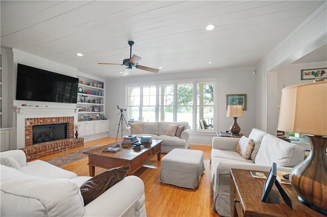 3009 Riverside Dr, Mobile, AL 36605 - living area with light wood finished floors, a ceiling fan, a brick fireplace, built in features, and recessed lighting