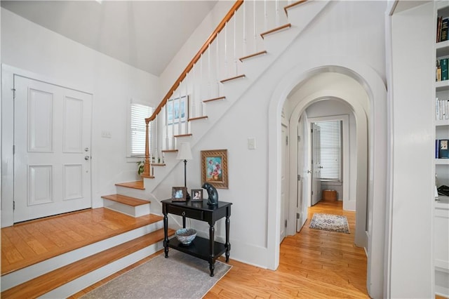 3009 Riverside Dr, Mobile, AL 36605 - foyer featuring light wood-style flooring, stairs, and arched walkways
