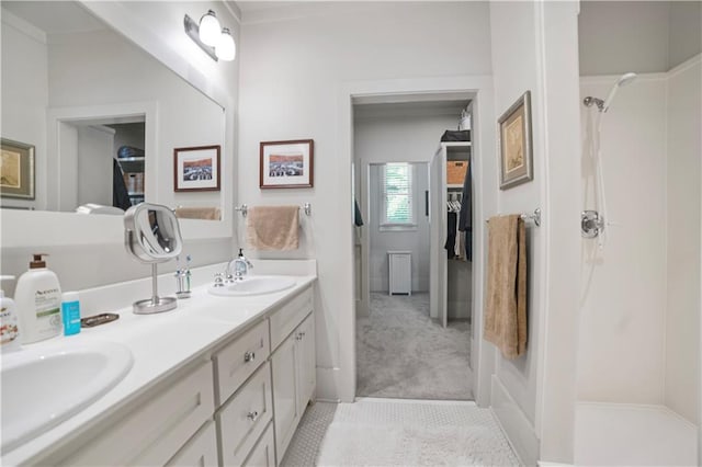 3009 Riverside Dr, Mobile, AL 36605 - bathroom with double vanity, a shower, and a walk in closet
