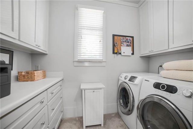 3009 Riverside Dr, Mobile, AL 36605 - laundry room featuring cabinet space, washing machine and clothes dryer, and light carpet