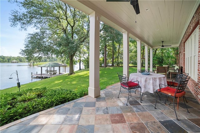 3009 Riverside Dr, Mobile, AL 36605 - view of patio / terrace with ceiling fan, a water view, a boat dock, outdoor dining space, and boat lift