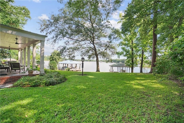 3009 Riverside Dr, Mobile, AL 36605 - view of green lawn with a gazebo, a ceiling fan, a water view, and a patio area