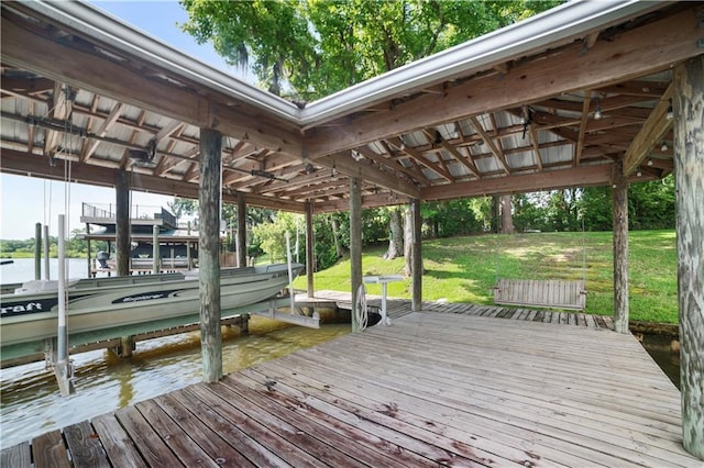 3009 Riverside Dr, Mobile, AL 36605 - dock area with boat lift, a water view, and a lawn