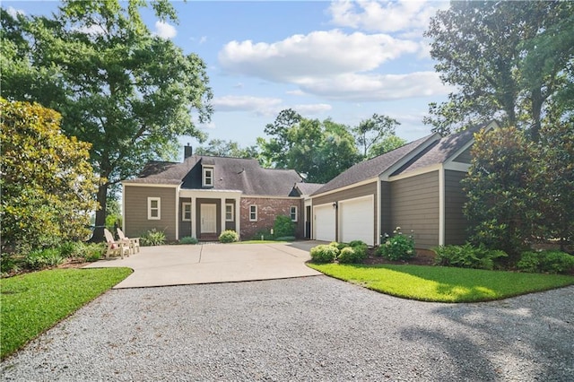 3009 Riverside Dr, Mobile, AL 36605 - view of front of home featuring concrete driveway, an attached garage, a chimney, and a front yard